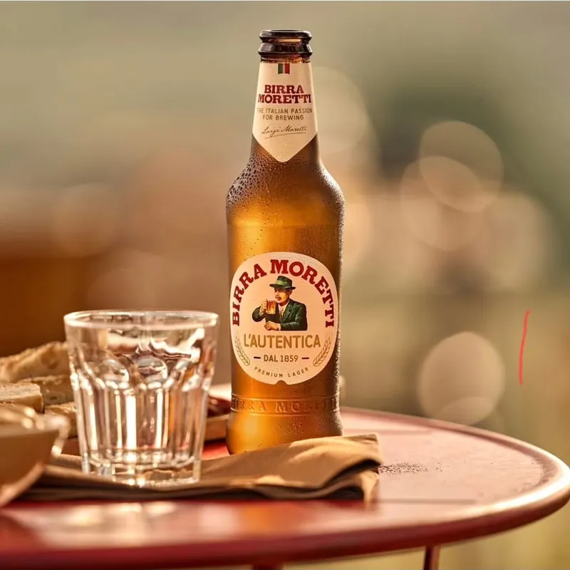 Flaša piva Birra Moretti i čaša na stolu